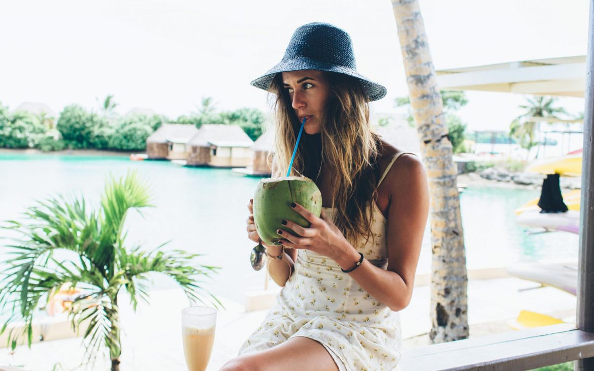 Lady drinking a coconut at Koro Sun Resort, Fiji