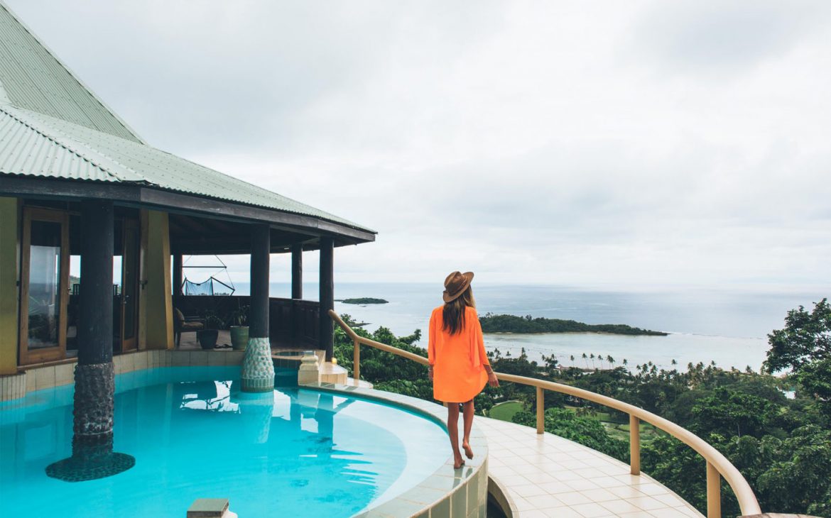 Lady walking by a pool at Koro Sun Resort, Fiji