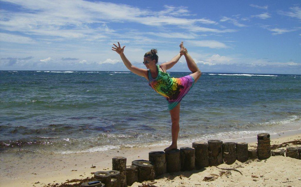 Woman practicing yoga by the water at Savusavu, Fiji