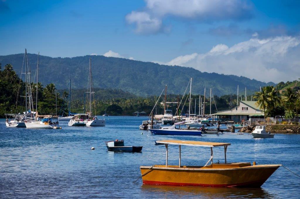 An assortment of vessels and yachts moored in Savusavu Bay.