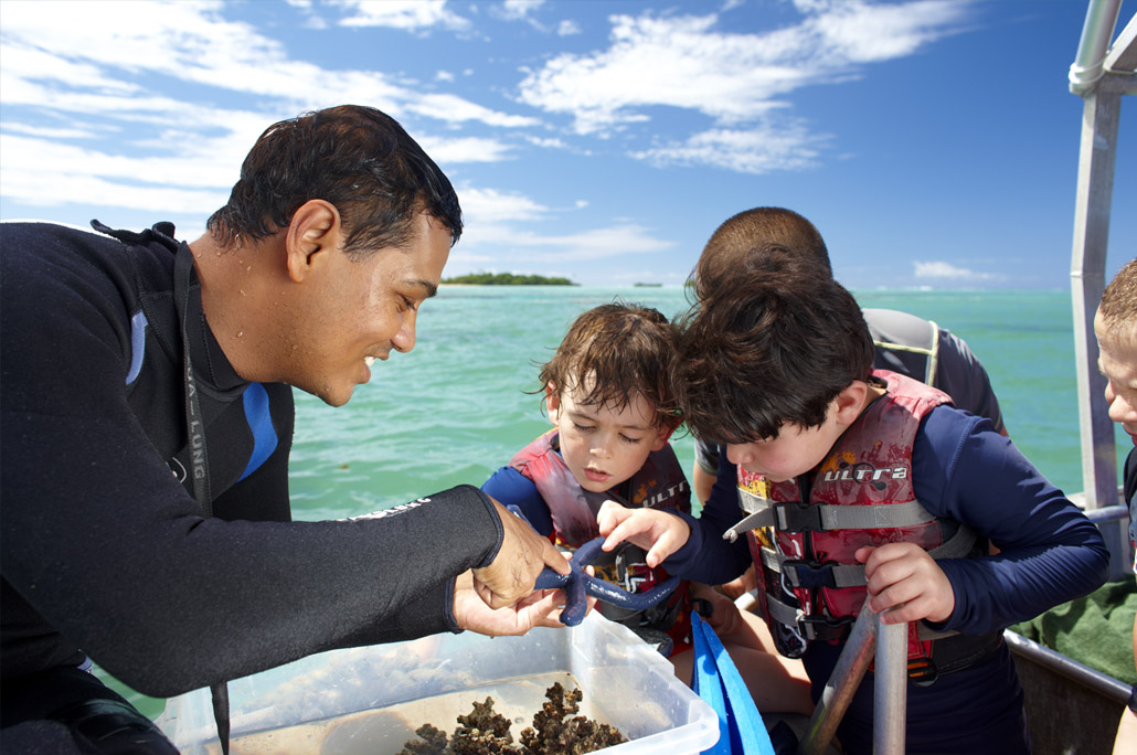 Children learn about starfish and other local marine life.