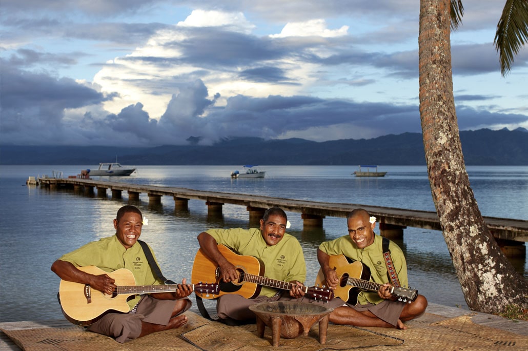 Guitarists sing to holidaymakers at Jean-Michel Cousteau Resort